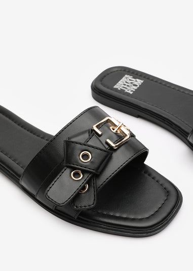 Where's That From Lucy Black Slip-On Sandals with Buckle Accent