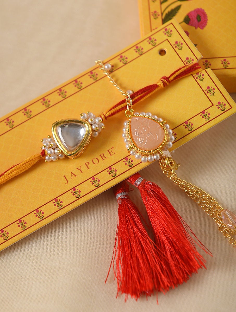 Women Red Gold Tone Kundan Handcrafted Rakhi With Peach Lumba (Set Of 2)