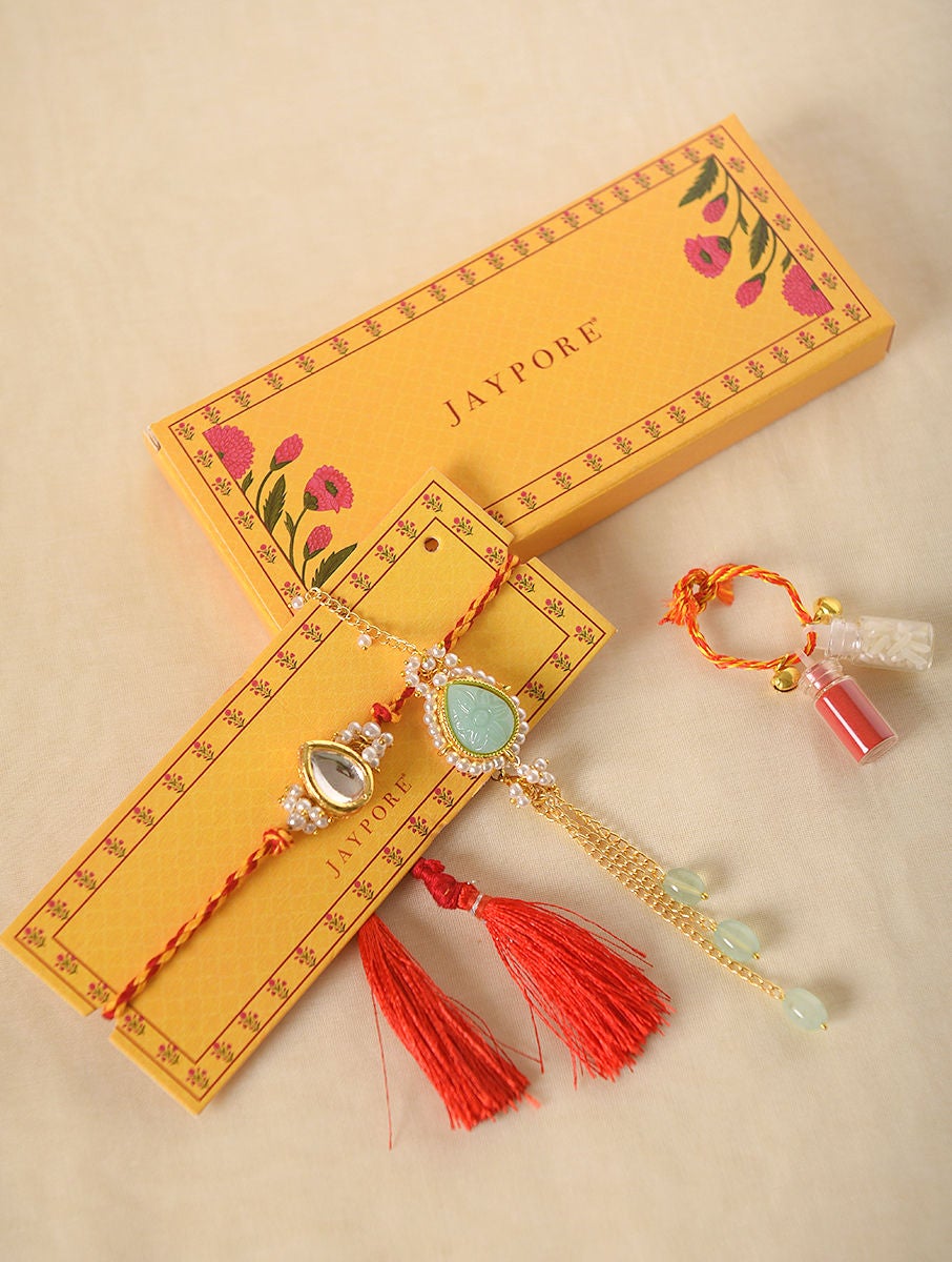 Women Red Handcrafted Kundan Rakhi With Blue Lumba (Set Of 2)