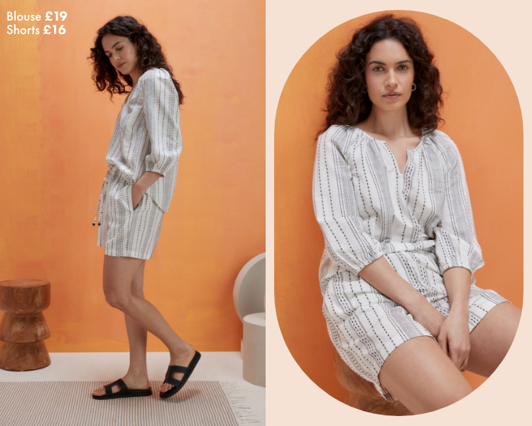 Woman wearing a black and white striped co ord. The set is a loose blouse with a v neck and 3 quarter length sleeves. This is worn with a matching pair of shorts with drawstring detail.​
