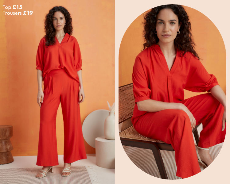 Woman wearing burnt orange trouser and blouse co ord styled with a pair of white sandal kitten heels with ankle strap. The co ord consists of a loose v neck, 3 quarter sleeve blouse tucked into a matching pair of wide leg pleated trousers.​