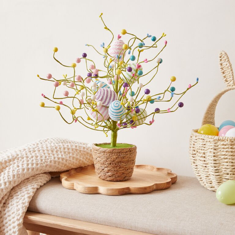 Kitchen decorated with Easter decorations including colourful Egg ornaments, wooden bunny ornaments, an Easter wreath and Easter bunting.