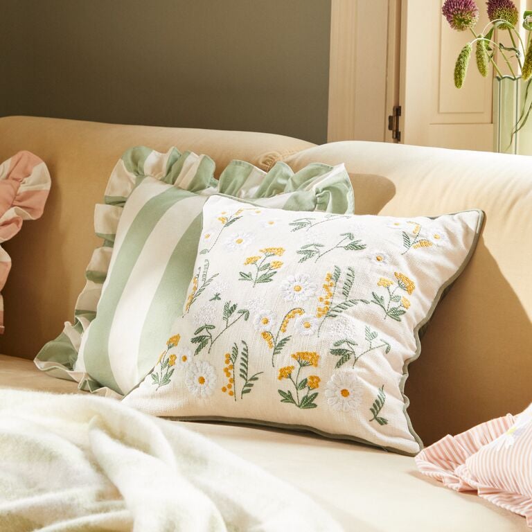 Bunny themed cuddle cushion on a bed.
