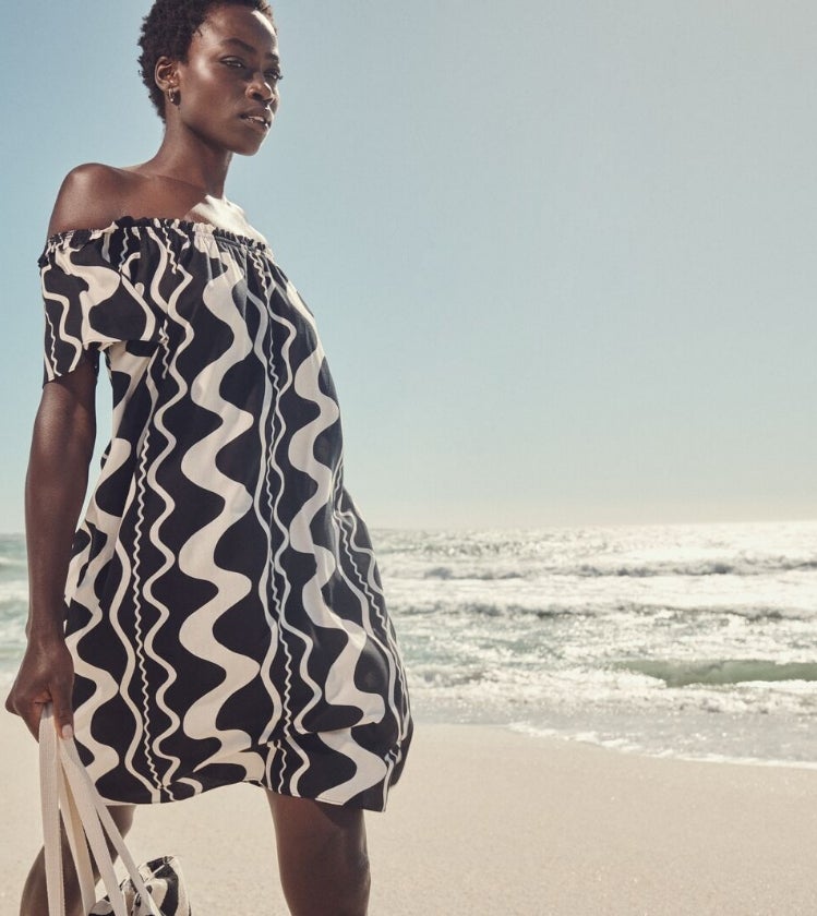 Woman wearing black and white dress as a beach outfit