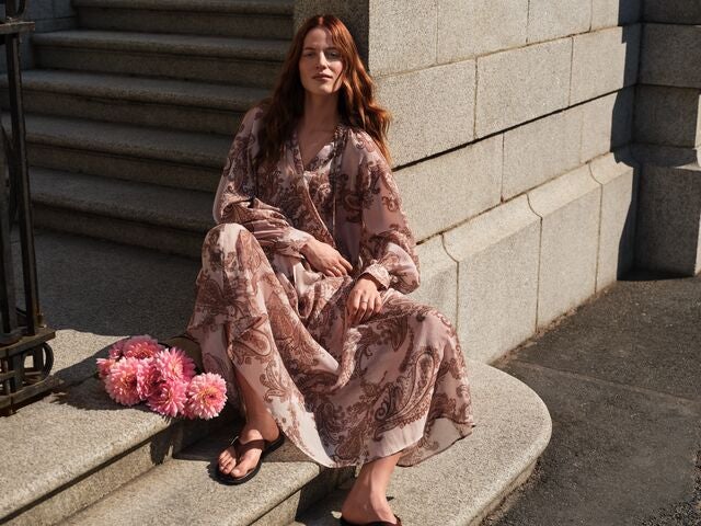 Model wearing a white and pink floral dress